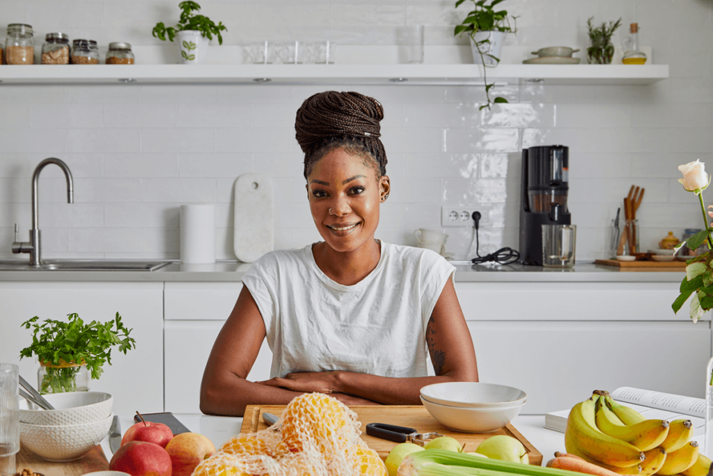 Black woman in nice modern kitch eating immune-boosting foods